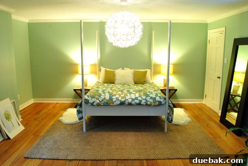 Full view of a redesigned bedroom featuring a new jute rug, bed, and coordinated furniture.