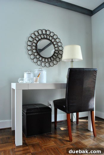 The Desk's Reflective Orbit 3 Detailed close-up of the oil-rubbed bronze frame of a round mirror, showcasing its intricate design and rich finish.