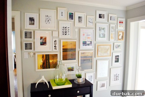 Adjusted hallway gallery wall with added filler items for a more balanced look