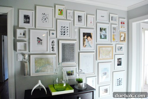 Various frames on the hallway gallery wall, showcasing different sizes and styles