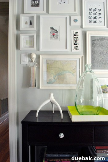 Close-up of a section of the gallery wall featuring framed photos and art