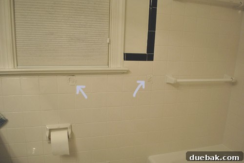 Clever Trim Tricks for Damaged Tiles 3 Close-up of careful chiseling to remove old towel bar brackets