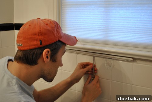Clever Trim Tricks for Damaged Tiles 6 Removing existing faux trim under the bathroom windowsill