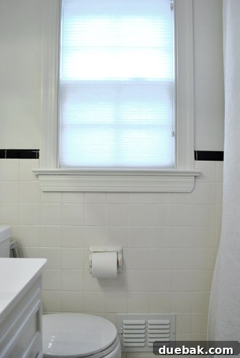 Clever Trim Tricks for Damaged Tiles 9 Full view of the updated bathroom with new window trim and high shower curtain