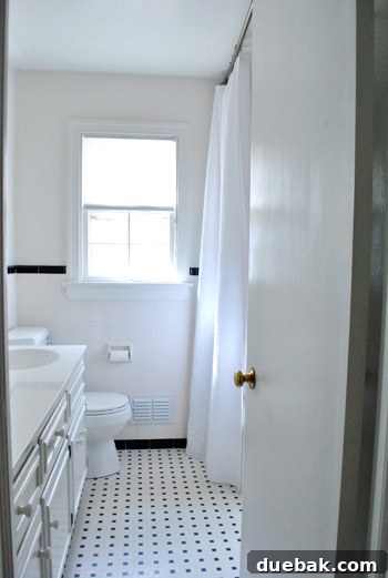 Clever Trim Tricks for Damaged Tiles 10 Bright, white bathroom showcasing the renovated window and shower area