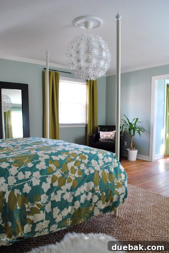 Another perspective of the bedroom with the vintage dresser