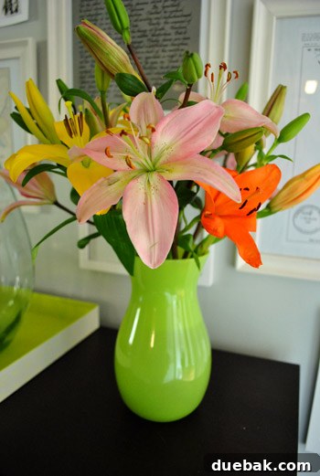 Beautiful bouquet of lilies in a lime green vase
