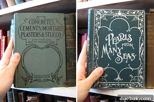 A stack of old, graphic books with titles like 'Concrete', showcasing their aesthetic appeal.