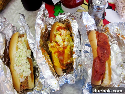 A close-up shot of a gourmet hot dog from Hillbilly Hot Dogs with various unusual toppings.