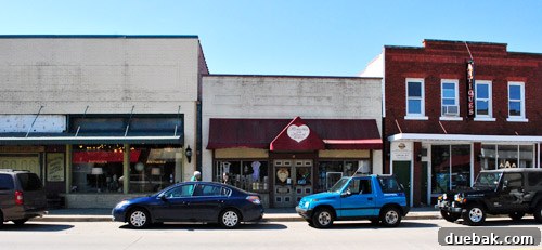 An outdoor view of a street in Old Central City, Huntington, showing vintage storefronts.