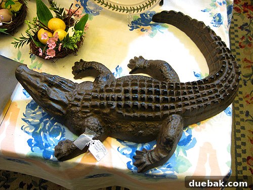 A large, rustic iron alligator sculpture, a charming antique find.