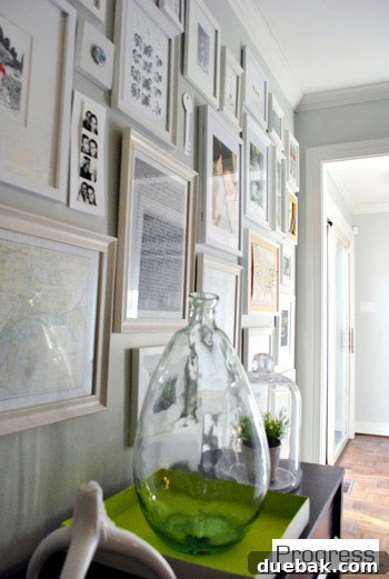 Current view of the hallway from the front door, showing gallery wall progress and paper templates