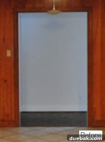 Before view of the hallway seen through the kitchen doorway