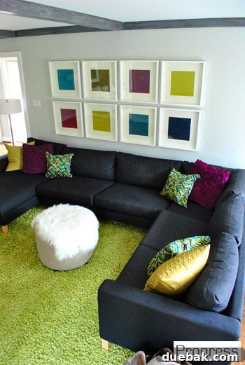 Another view of the updated living room, showcasing improved lighting and decor
