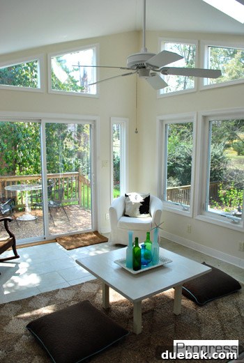 Current state of the sunroom with existing furniture, awaiting major painting and decor