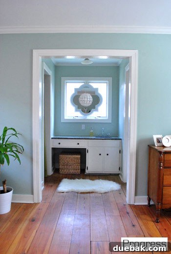 Transformed master sink nook with removed bi-fold doors, new mirror, and updated vanity