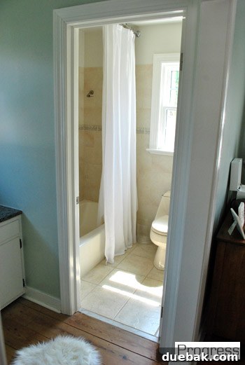Current master bathroom, largely unchanged except for a higher shower curtain