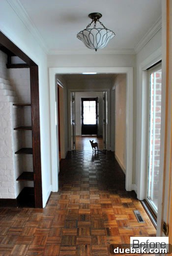 Before view of the hallway facing the front door from the master bedroom
