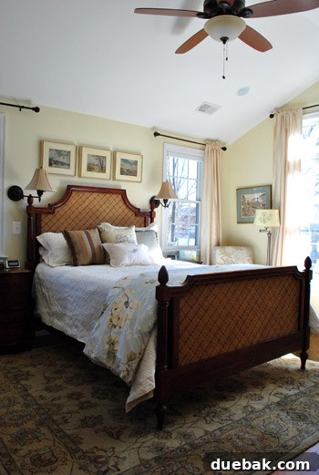 Bright and airy main bedroom with a high peaked ceiling and large windows