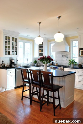 Luxurious kitchen island with vintage-style pendant lights and glass-front cabinets