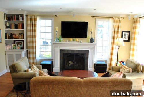 Cozy family room connected to the kitchen, featuring a gas fireplace and built-in bookshelves