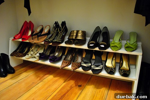 Organized shoe collection on shelves in a closet