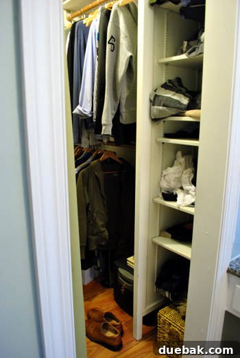 Close-up of cluttered closet shelves and hanging clothes