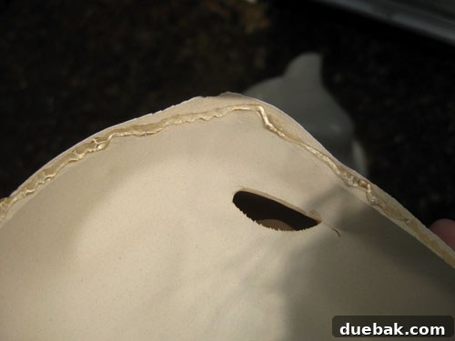Detailed shot of hands applying super glue to a ceramic fragment on a patio table