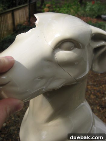 Another perspective of the ceramic repair in progress, showing several pieces glued