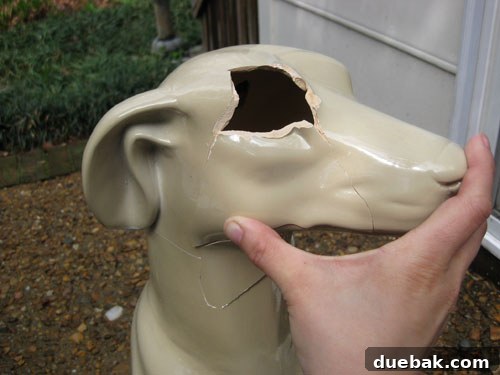 An overhead view of the partially reassembled ceramic dog, revealing visible gaps
