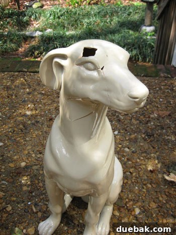 Side view of the reassembled ceramic dog, emphasizing the jagged and unmatching lines