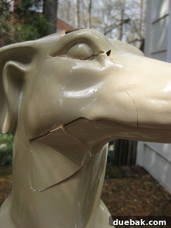 Final state of the repaired ceramic dog, showing pronounced cracks and uneven surfaces