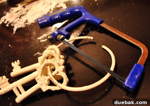 Large Painted Metal Keys on Display 4 Iron ring being cut with a hacksaw to separate the keys for individual display.