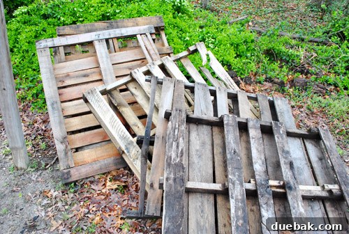 Stacked pallets waiting to be deconstructed for a DIY console table top