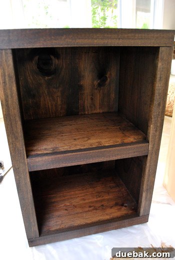 Well-lit close-up of dark walnut stained wood on console table shelves