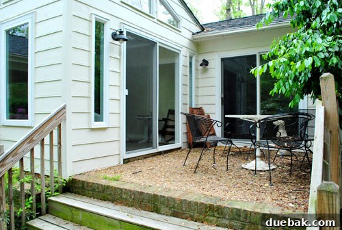 First Look: Our New Home's Exterior 20 Small existing patio off the sunroom and living room with outdoor furniture