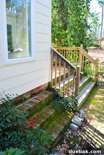 First Look: Our New Home's Exterior 21 Original brick staircase leading to the enclosed sunroom, highlighting a design anomaly