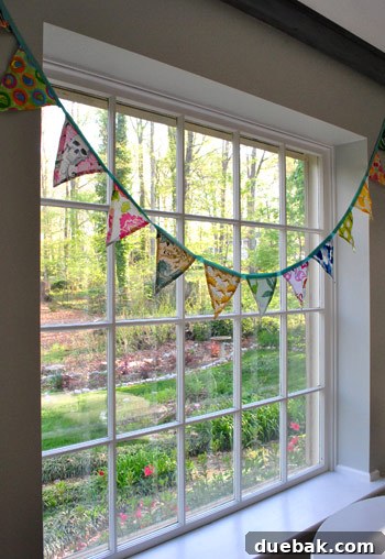 Colorful fabric flag banner laid out, featuring various patterns.
