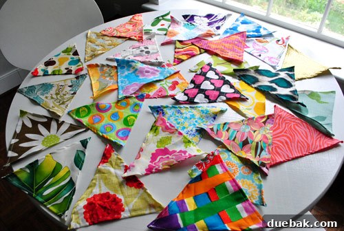 Various fabric triangles cut and prepared for the flag banner project.