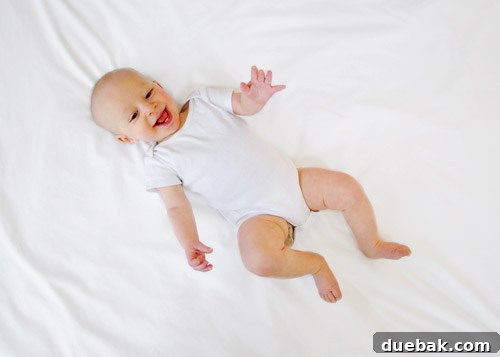 Crafting Memorable First Birthday Invitations 6 Baby Clara lying on a plain white sheet, ready for photo manipulation.