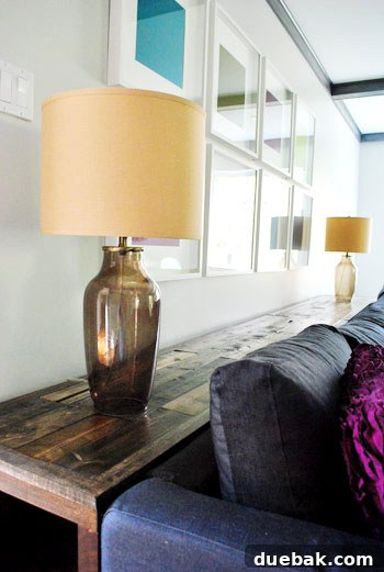 Two bedside lamps temporarily placed on the console table, demonstrating its width and potential for accessorizing.