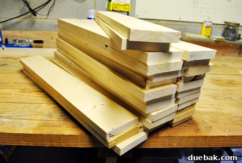 Neatly cut two-foot lengths of whitewood boards, prepared for distressing and assembly into the console tabletop.
