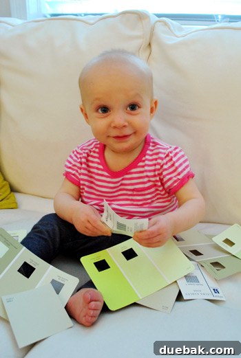 Gift the Canvas of Imagination 12 Clara, a young child, looking intently at paint swatches on a wall.