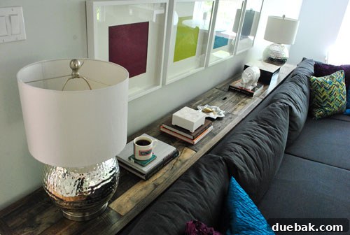 Detailed shot of the stacked books and white capiz box, showcasing functional decor.