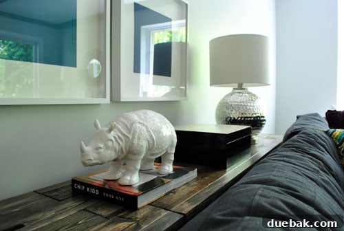 A ceramic rhino figurine on the console table, adding a playful touch to the decor.