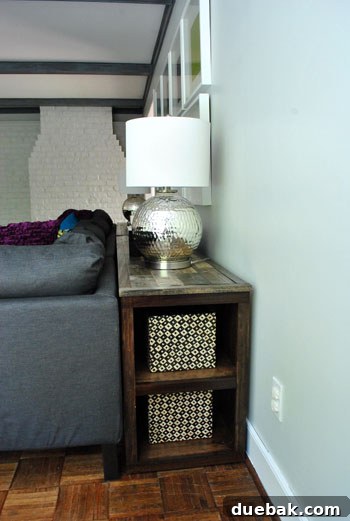 Far side of the console bookshelf with two baskets containing blocks and small toys.