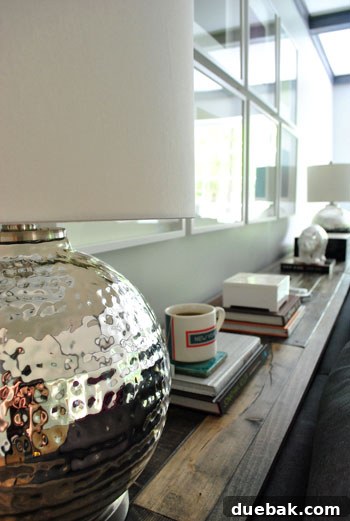 A stack of hardcover books on the console, with a small decorative box.