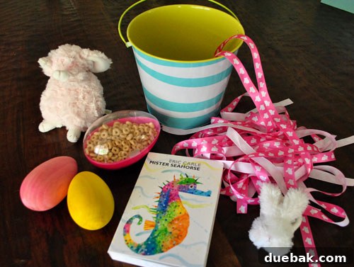 Easter Steals 13 Clara happily playing with her Easter basket, surrounded by its contents