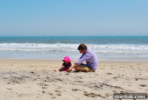 Easter Steals 15 Clara sitting on the sandy beach, observing her surroundings with curiosity