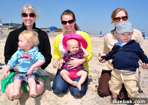 Easter Steals 22 Three babies and their mothers enjoying time together on a windy beach
